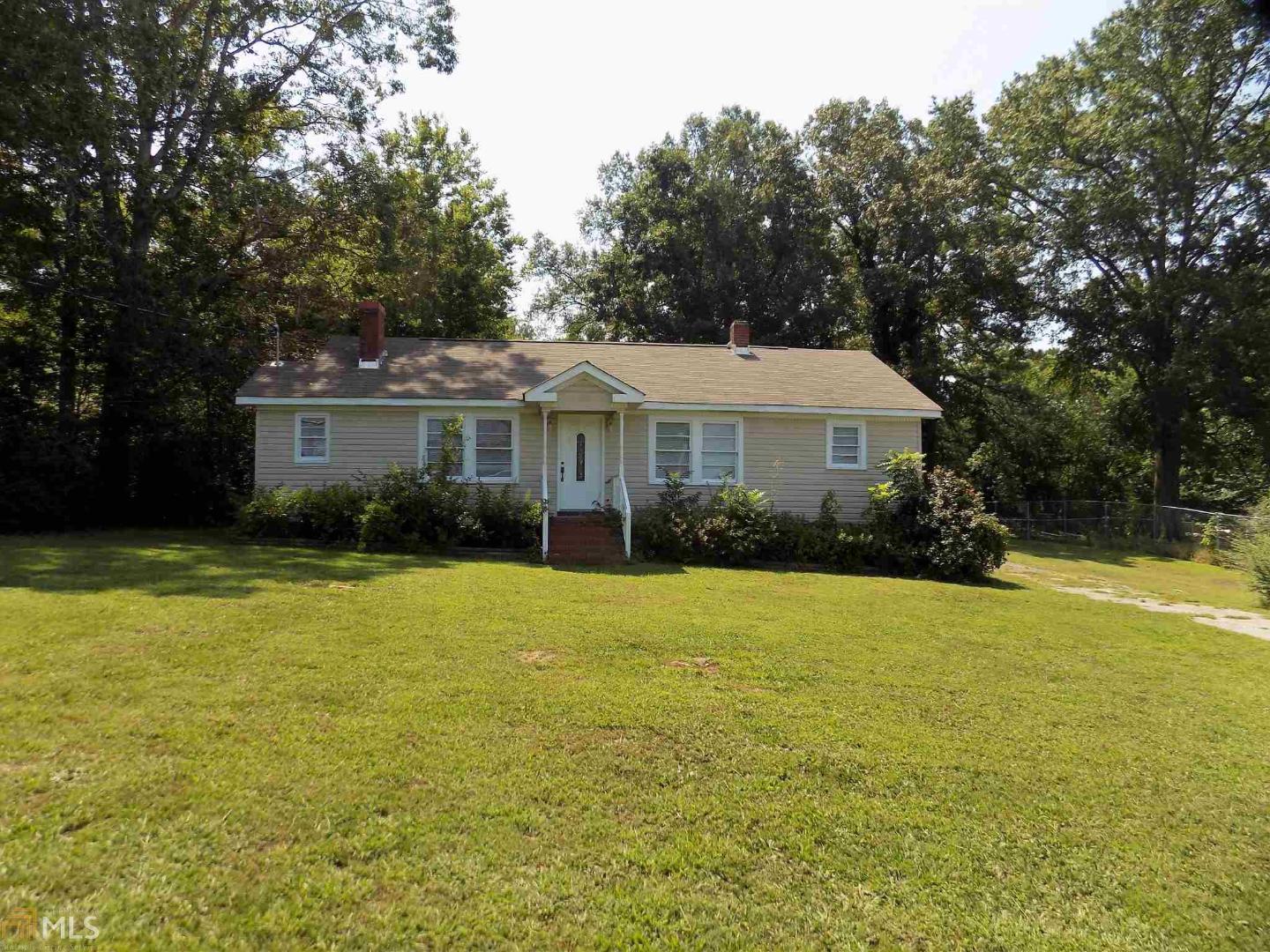 4420 Calhoun Highway Northeast Rome, GA 30161 - Photo 1 of 1 a front view of a house with a yard and trees