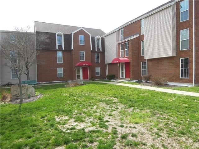 a view of a brick building next to a yard