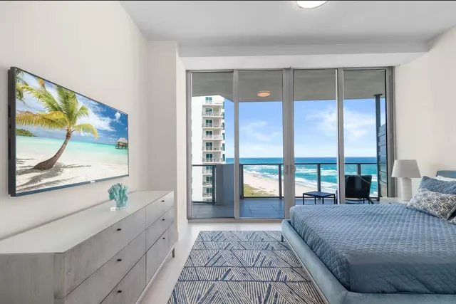 a spacious bedroom with a large bed and a large window