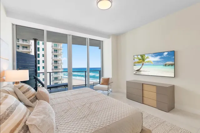 a bedroom with a large bed and a large window