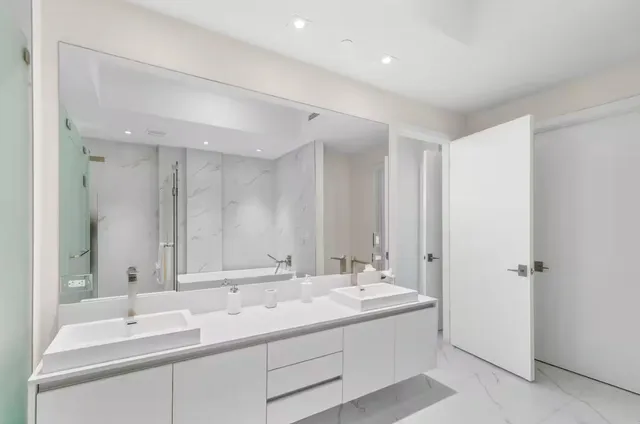 a bathroom with a double vanity sink mirror and double