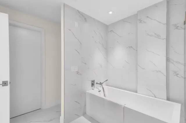 a bathroom with a bathtub and a shower