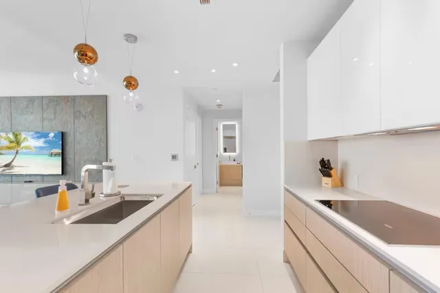 a kitchen with a sink and a stove top oven