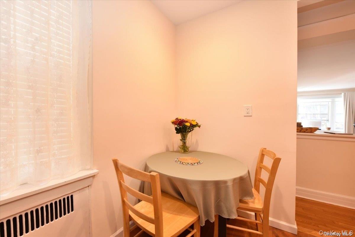 175-06 Devonshire Road, Unit 1J Queens, NY 11432 - Photo 11 of 20 a dining room with furniture and wooden floor