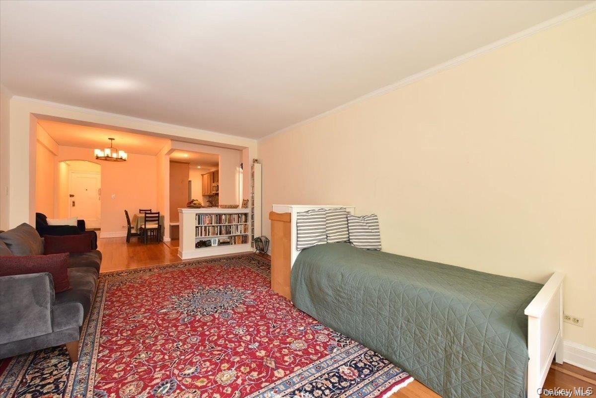 175-06 Devonshire Road, Unit 1J Queens, NY 11432 - Photo 5 of 20 a living room with furniture and a rug