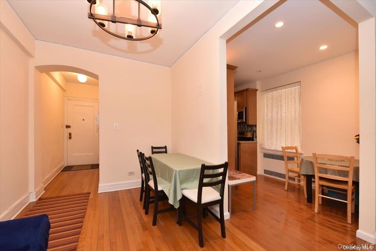 175-06 Devonshire Road, Unit 1J Queens, NY 11432 - Photo 7 of 20 a view of a dining room with furniture and wooden floor