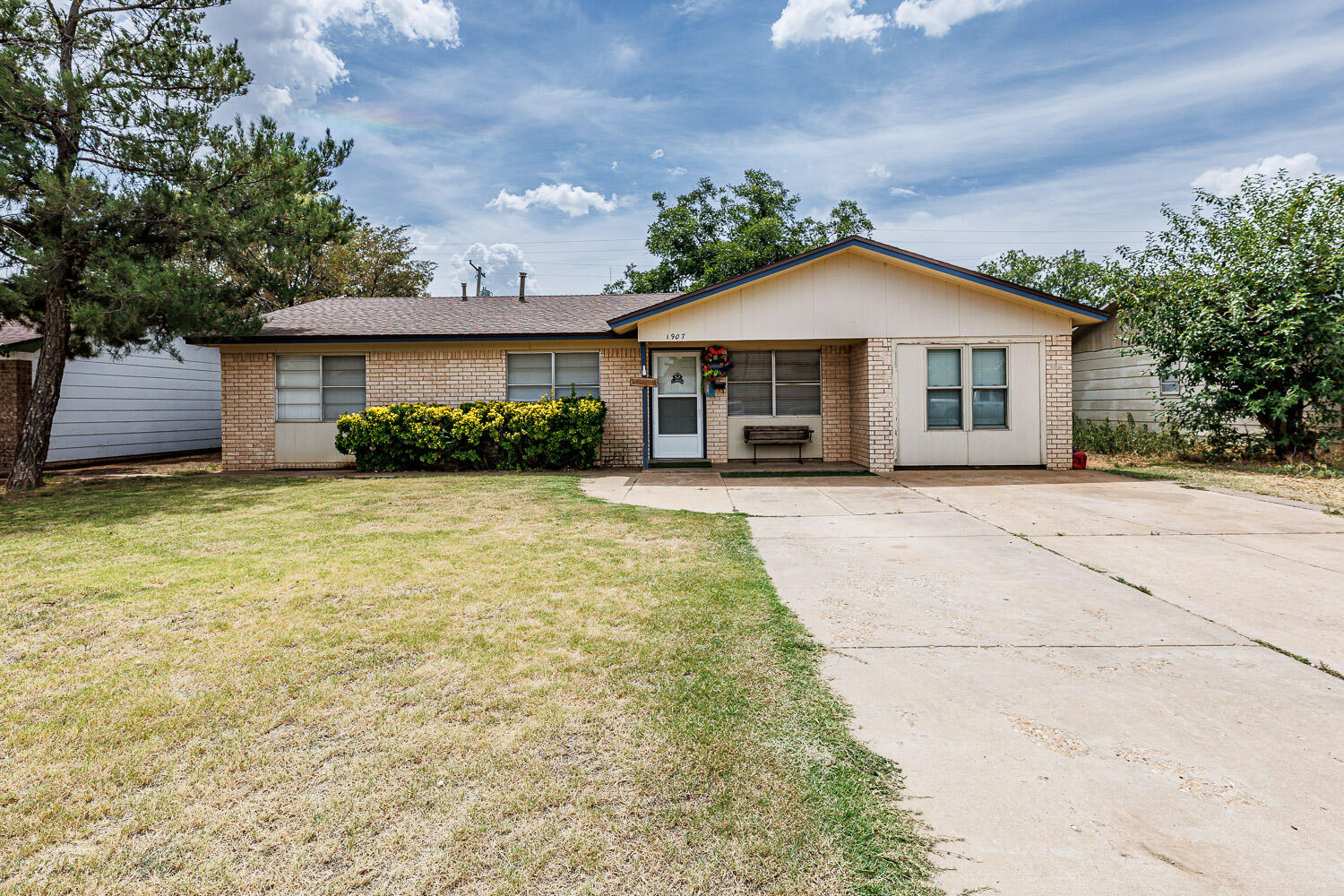 1907 73rd Street Lubbock, TX 79423 - Photo 1 of 41 a view of a house with a yard and potted plants