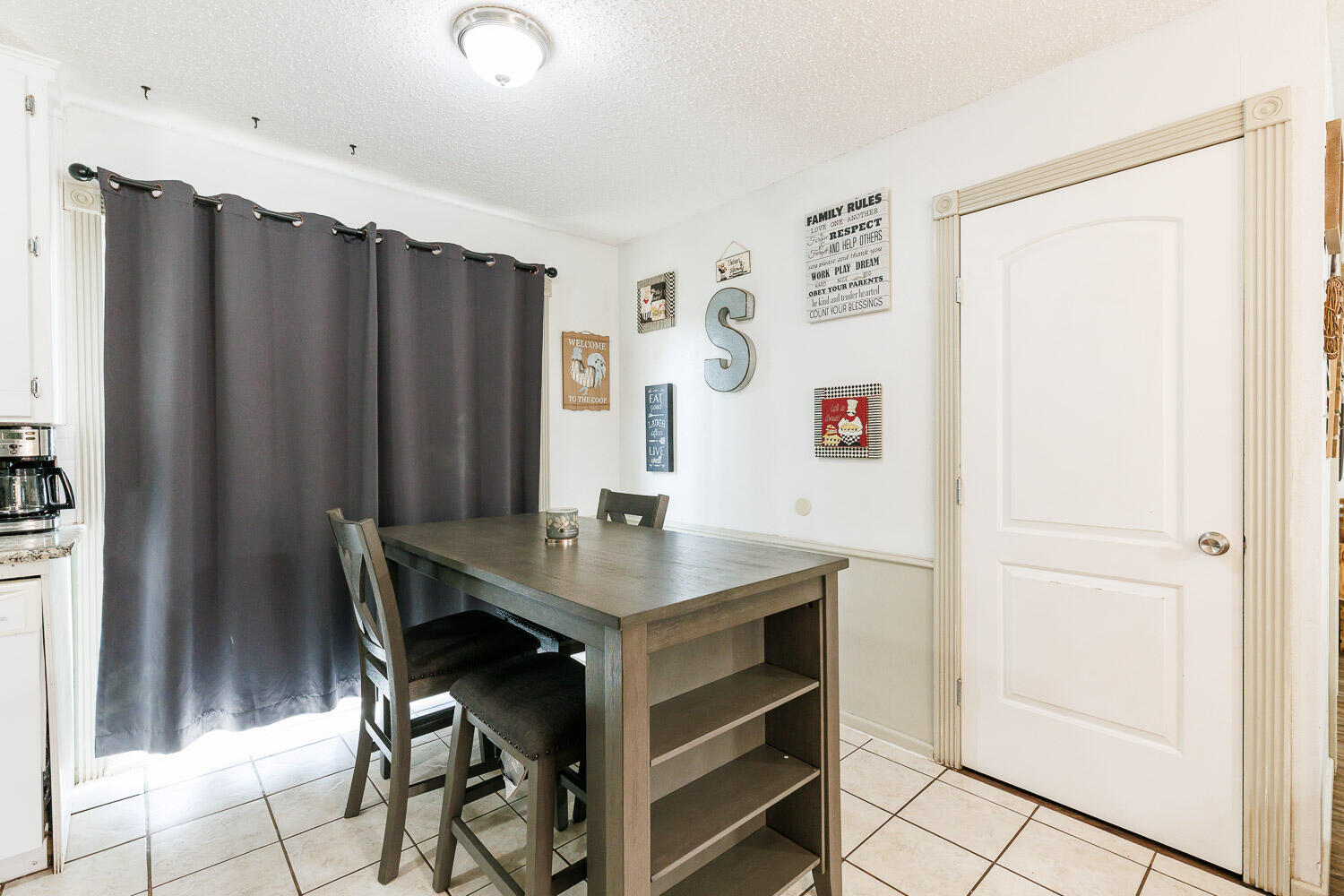 1907 73rd Street Lubbock, TX 79423 - Photo 11 of 41 a view of a dining room with furniture and a chandelier
