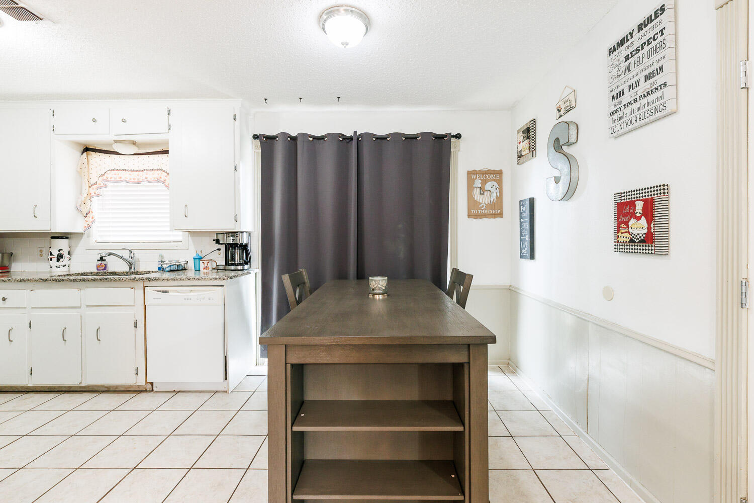 1907 73rd Street Lubbock, TX 79423 - Photo 12 of 41 a kitchen with cabinets and window
