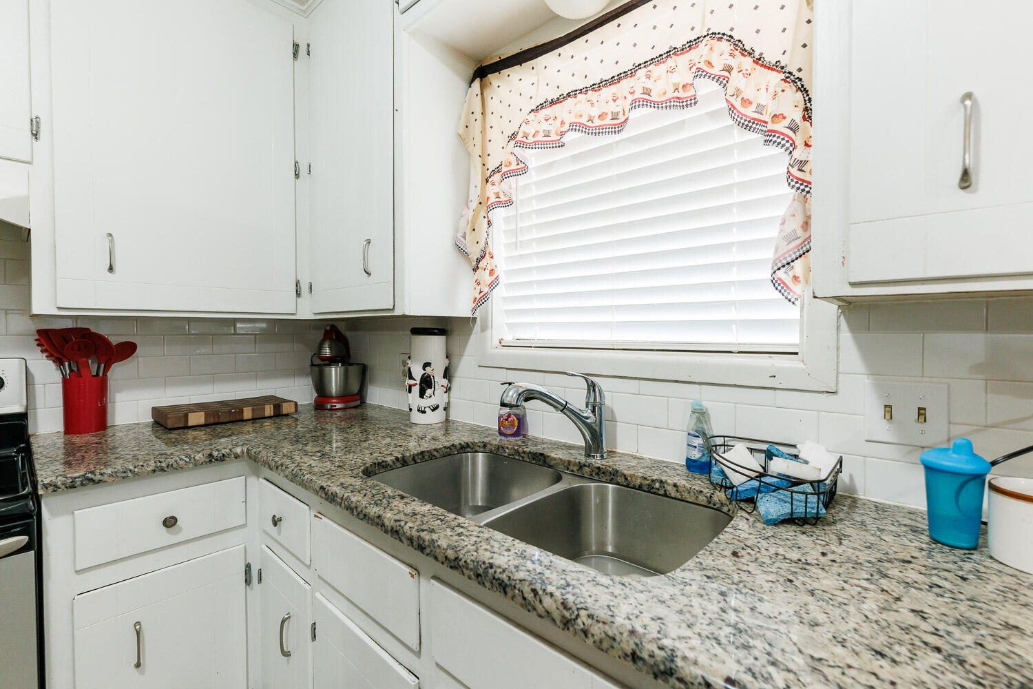 1907 73rd Street Lubbock, TX 79423 - Photo 13 of 41 a kitchen with a sink cabinets and window
