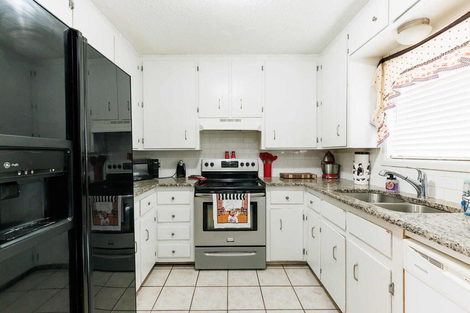 1907 73rd Street Lubbock, TX 79423 - Photo 14 of 41 a kitchen with granite countertop white cabinets and appliances
