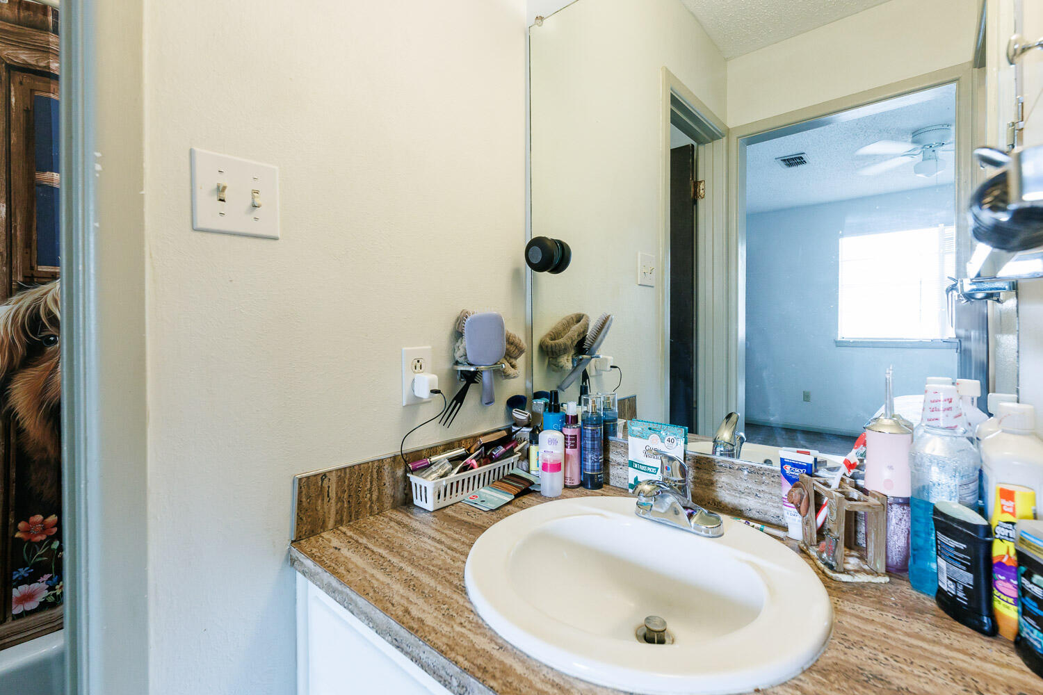 1907 73rd Street Lubbock, TX 79423 - Photo 22 of 41 a bathroom with a sink a mirror and vanity