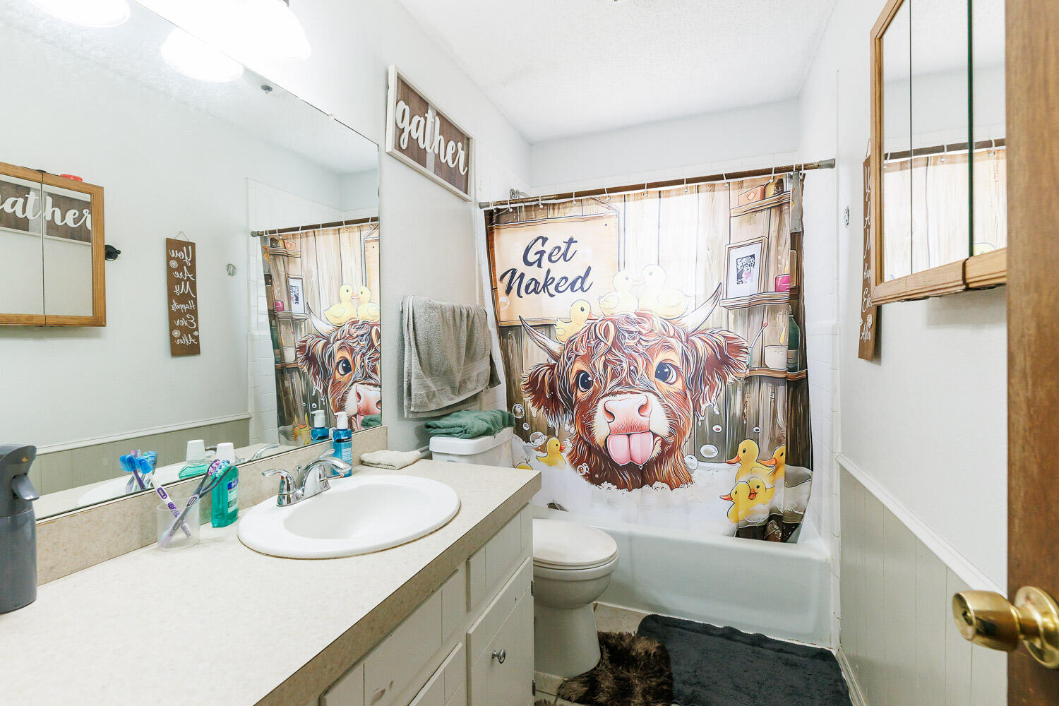 1907 73rd Street Lubbock, TX 79423 - Photo 27 of 41 a bathroom with a sink mirror vanity and toilet