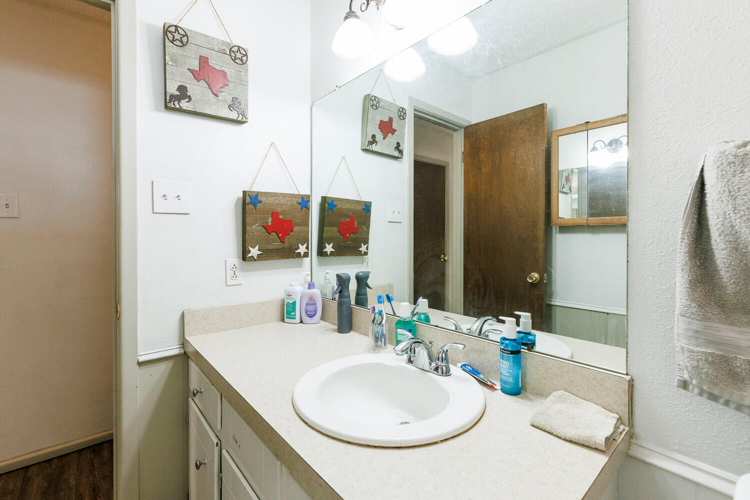 1907 73rd Street Lubbock, TX 79423 - Photo 29 of 41 a bathroom with a sink a mirror and a shower