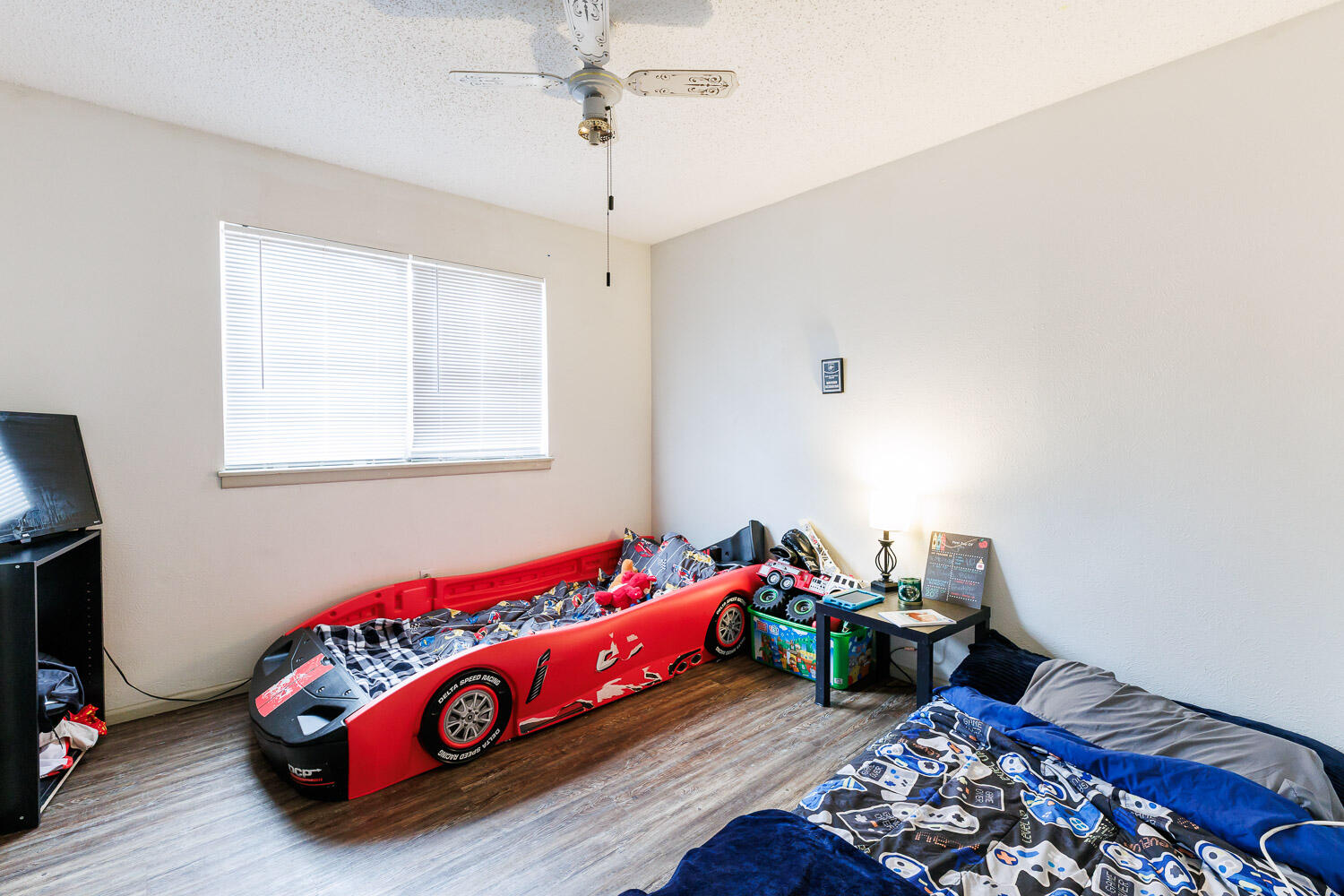 1907 73rd Street Lubbock, TX 79423 - Photo 30 of 41 a bedroom with bed and a chandelier