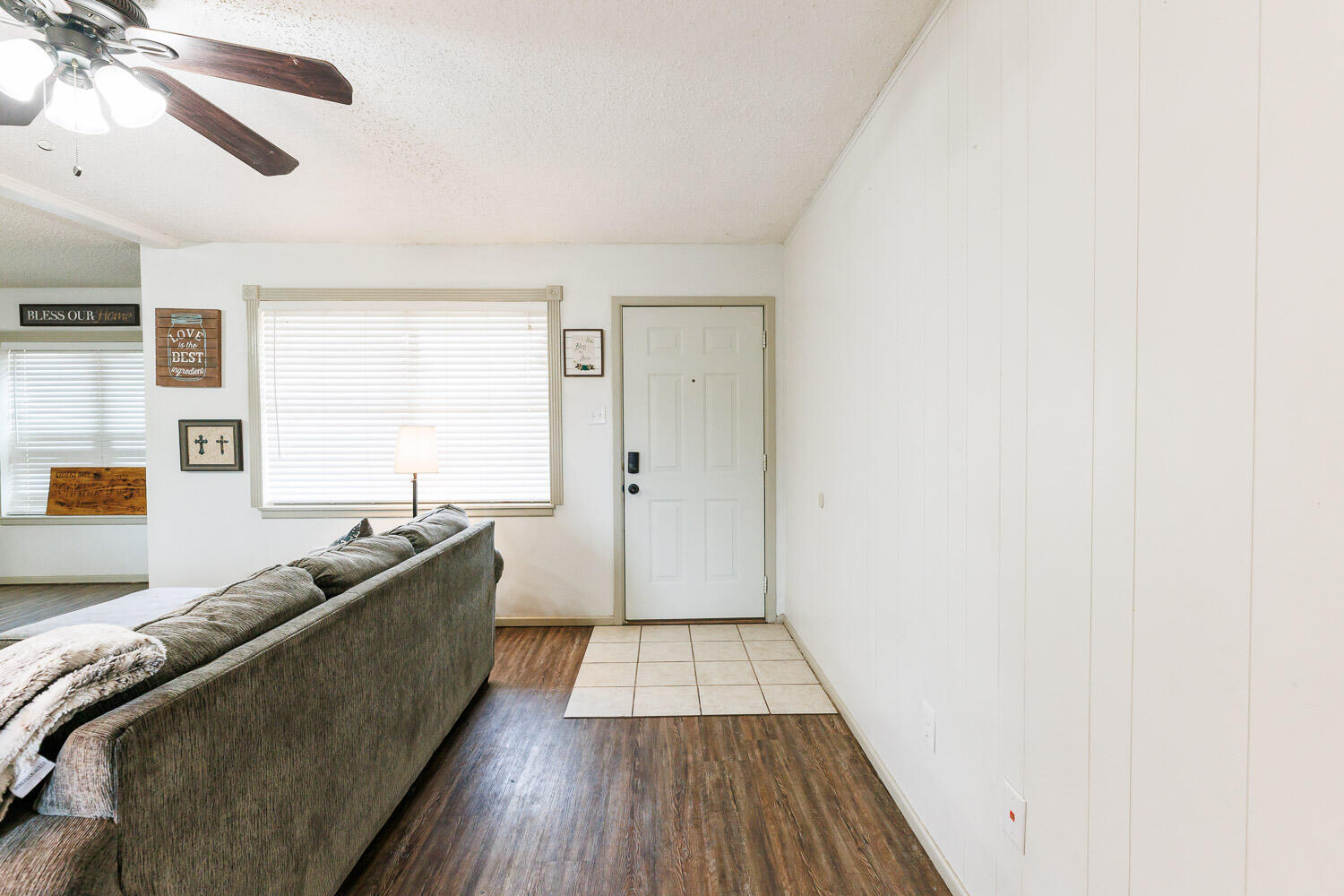 1907 73rd Street Lubbock, TX 79423 - Photo 6 of 41 a living room with a couch and a ceiling fan