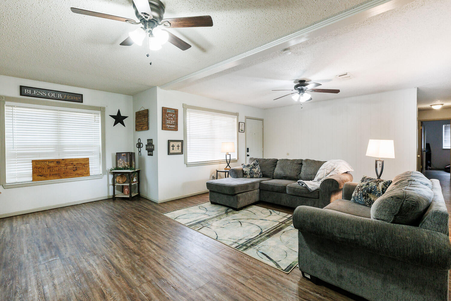 1907 73rd Street Lubbock, TX 79423 - Photo 8 of 41 a living room with furniture and a chandelier