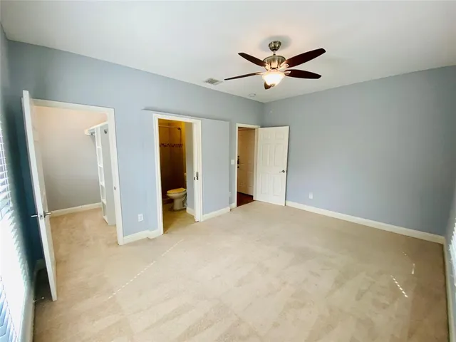 an empty room with closet and windows