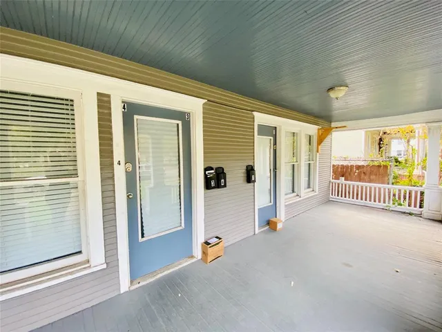 a view of a porch with a table and chairs