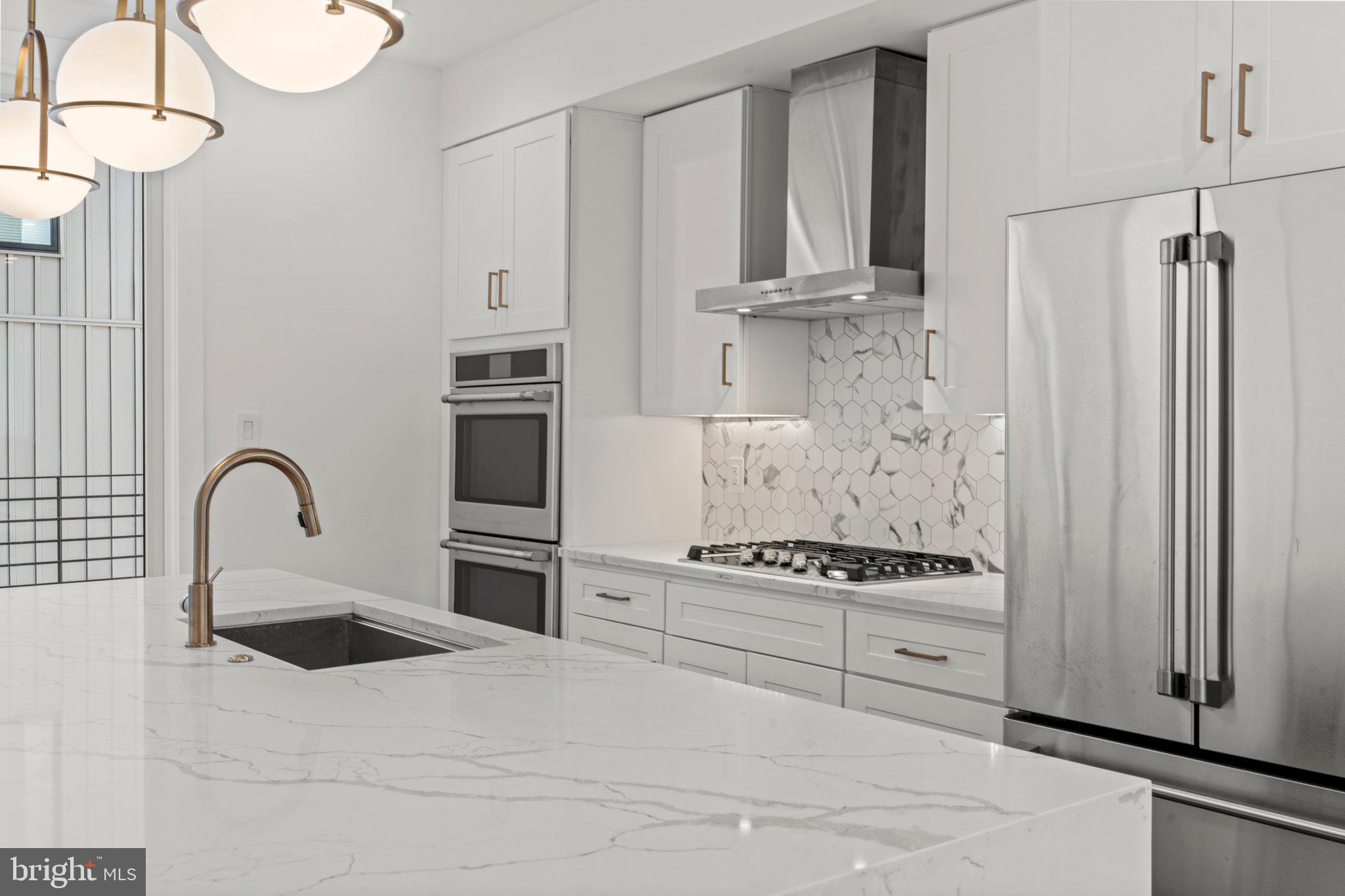 2240 League Street Philadelphia, PA 19146 - Photo 9 of 43 a kitchen with granite countertop a stove and a refrigerator