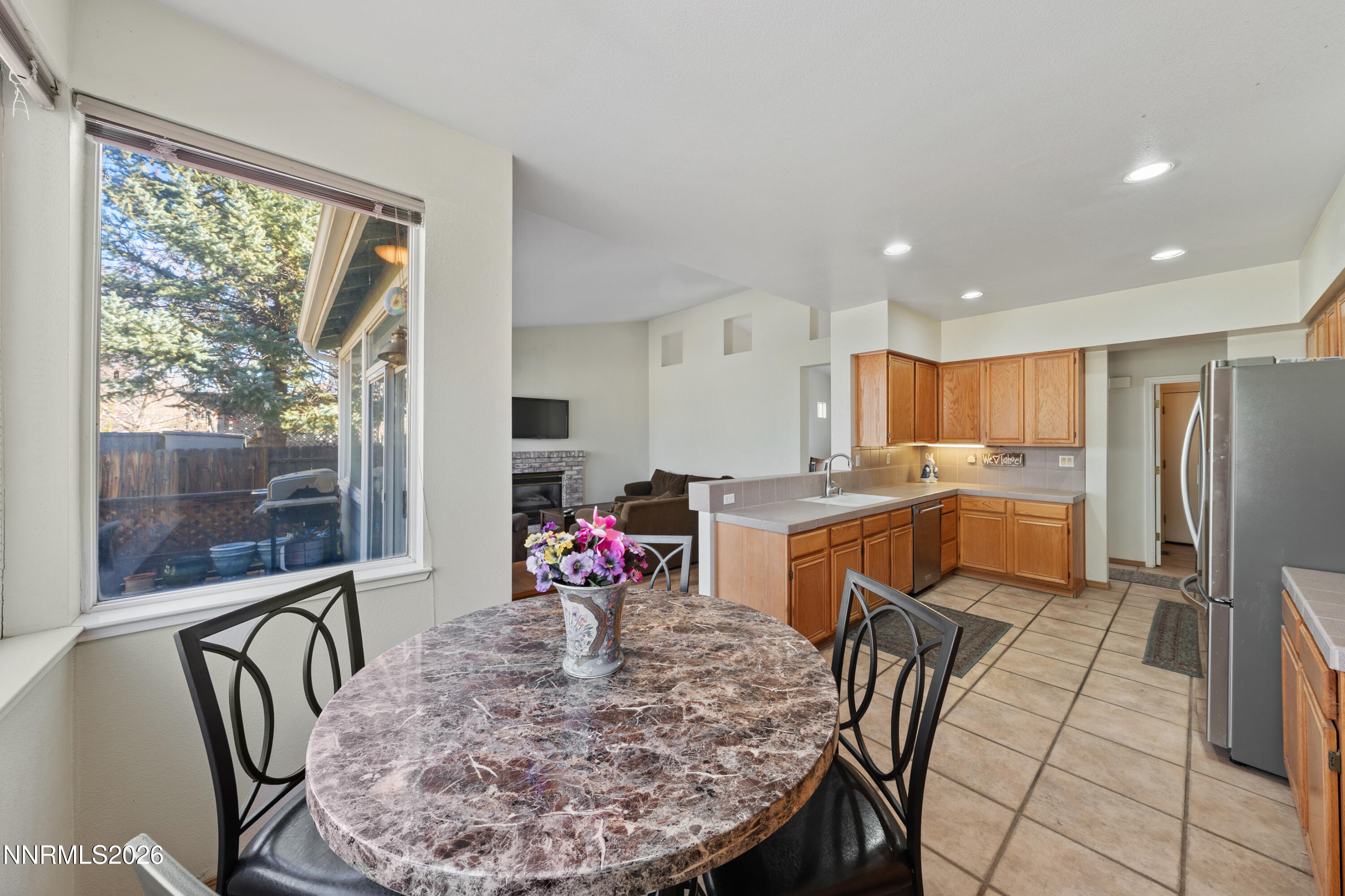 3225 Eaglewood Drive Reno, NV 89502 - Photo 13 of 45 a kitchen with a dining table chairs and refrigerator