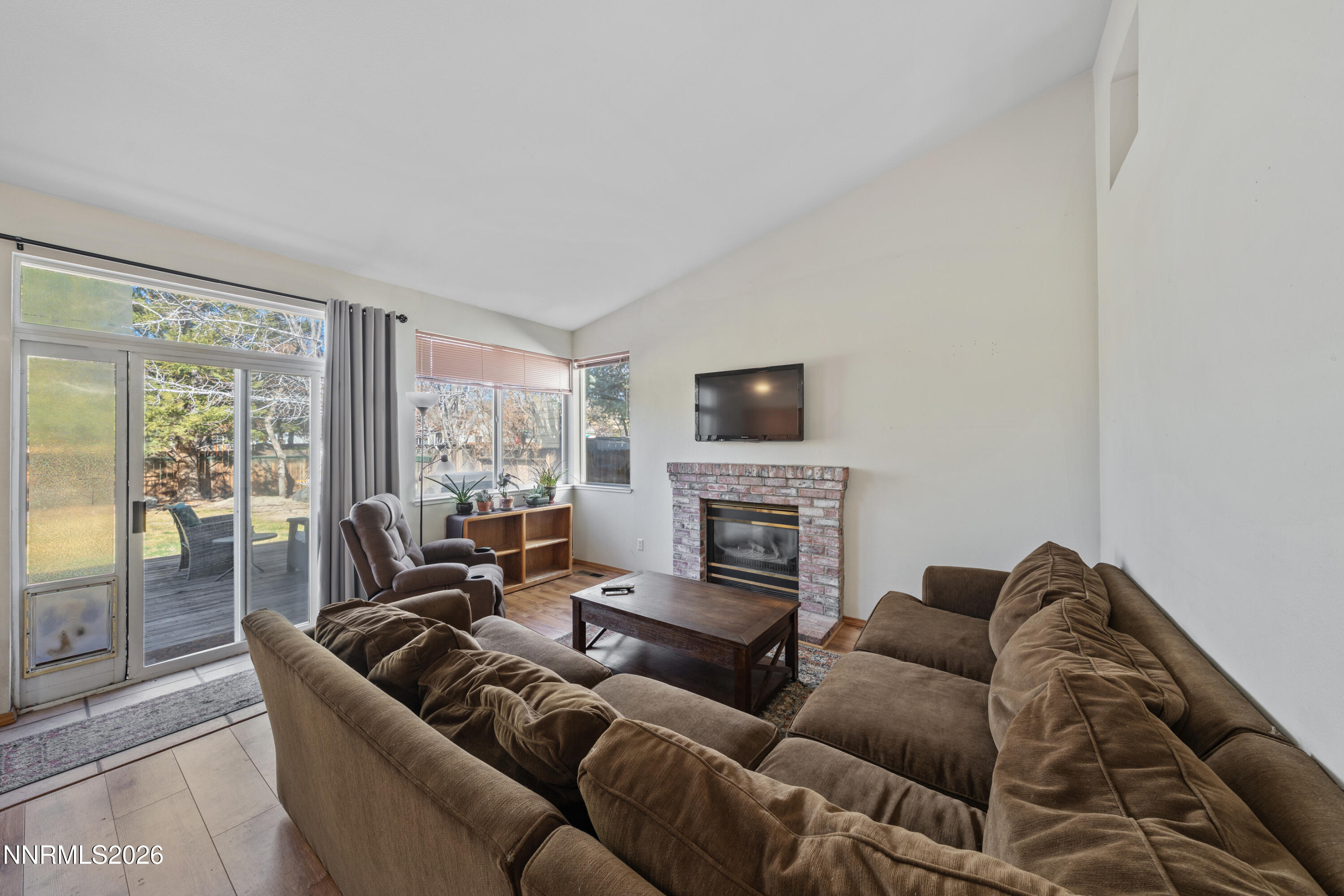 3225 Eaglewood Drive Reno, NV 89502 - Photo 15 of 45 a living room with furniture a large window and a flat screen tv