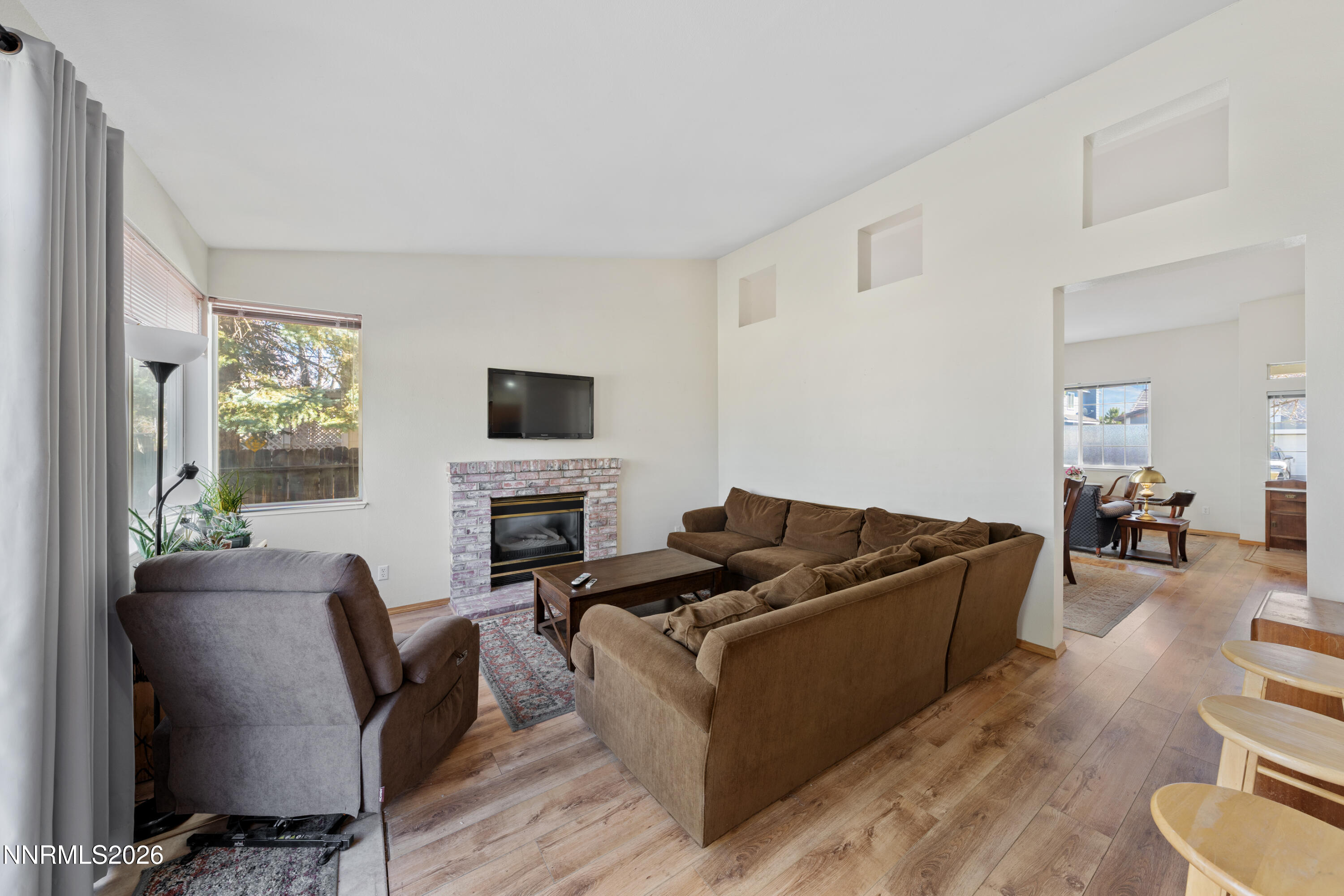 3225 Eaglewood Drive Reno, NV 89502 - Photo 16 of 45 a living room with furniture flat screen tv and a fireplace