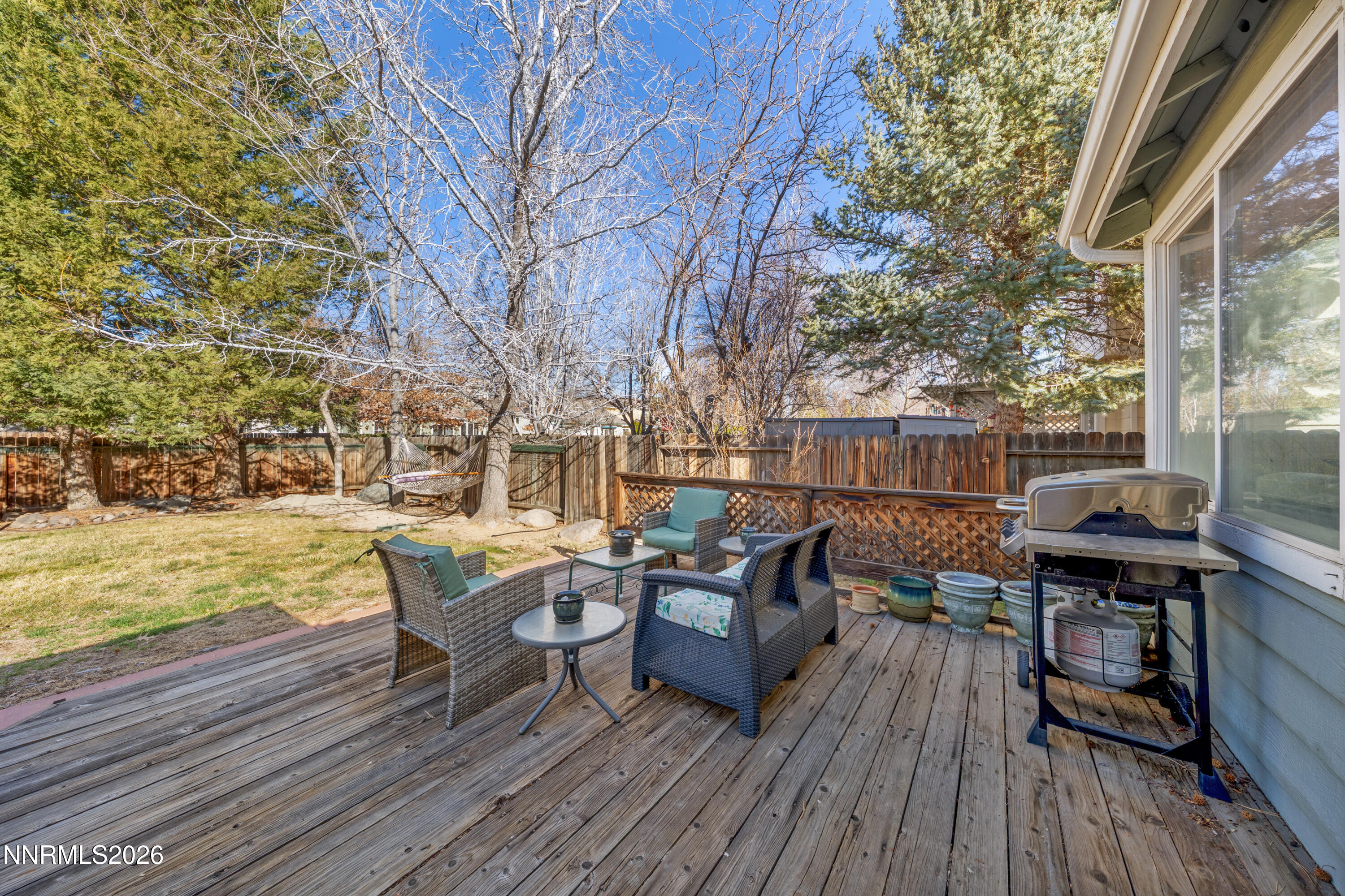 3225 Eaglewood Drive Reno, NV 89502 - Photo 31 of 45 a view of a roof deck with table and chairs wooden floor and fence