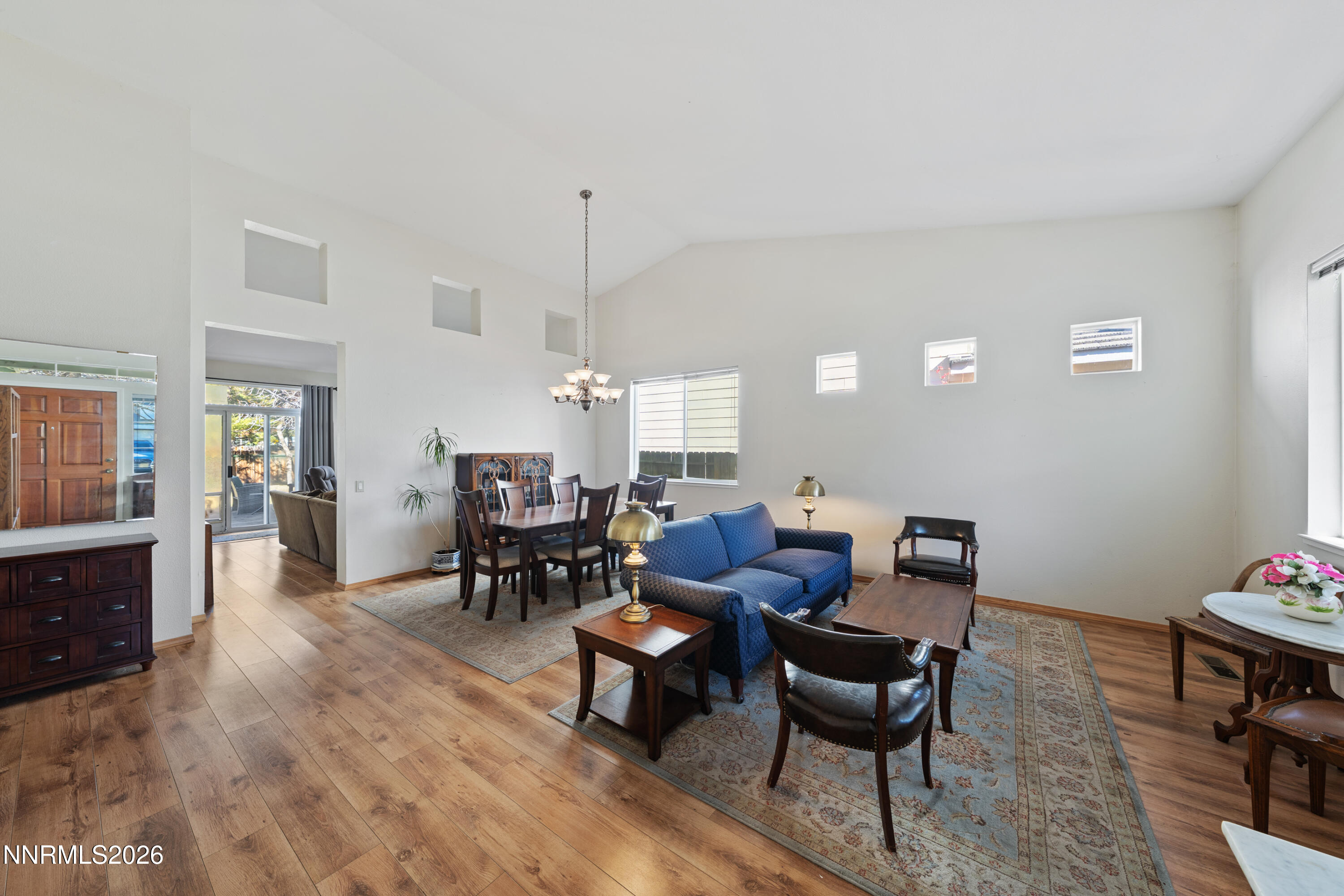 3225 Eaglewood Drive Reno, NV 89502 - Photo 5 of 45 a living room with furniture dining table a lamp and a window