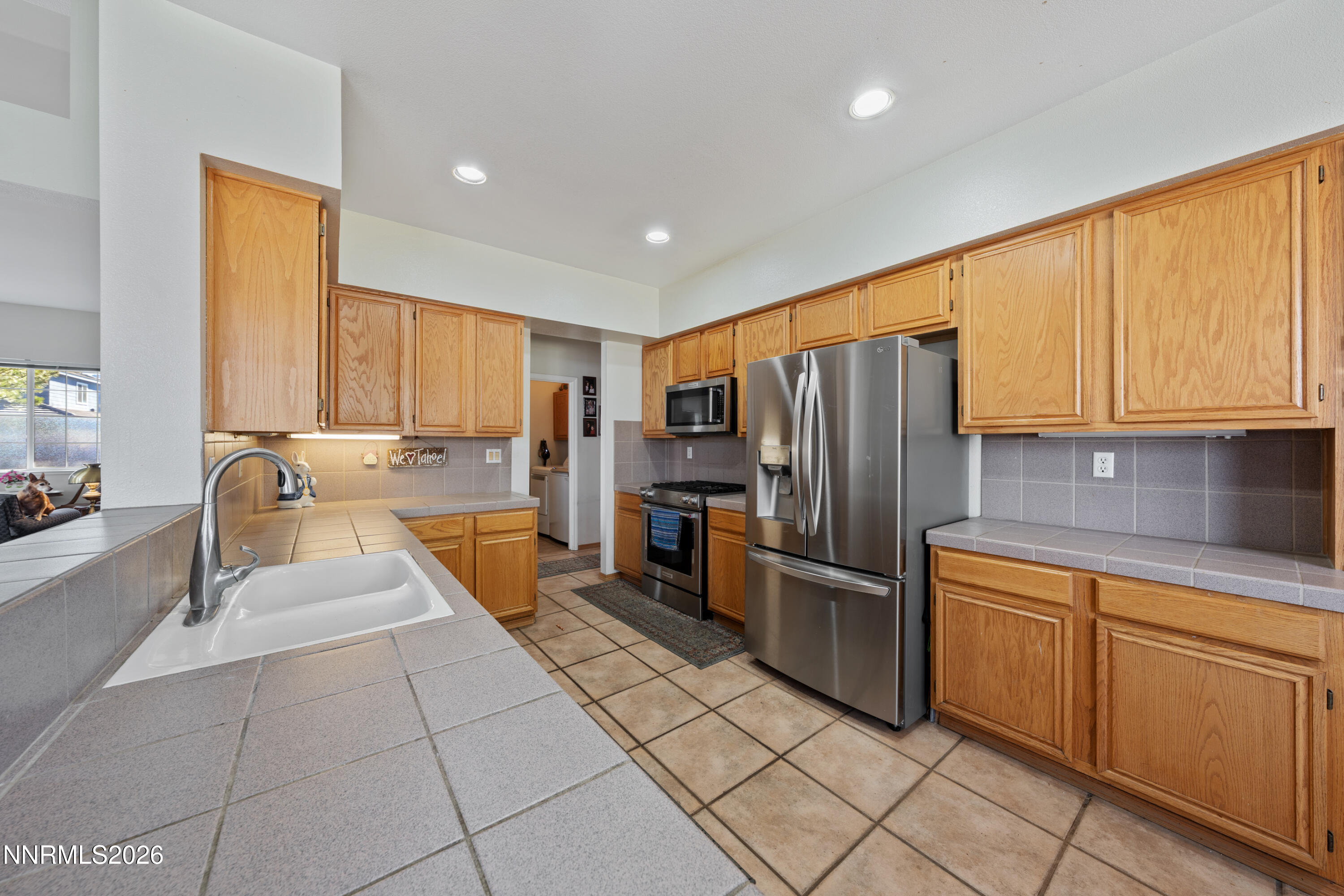 3225 Eaglewood Drive Reno, NV 89502 - Photo 6 of 45 a kitchen with stainless steel appliances granite countertop a refrigerator and a sink