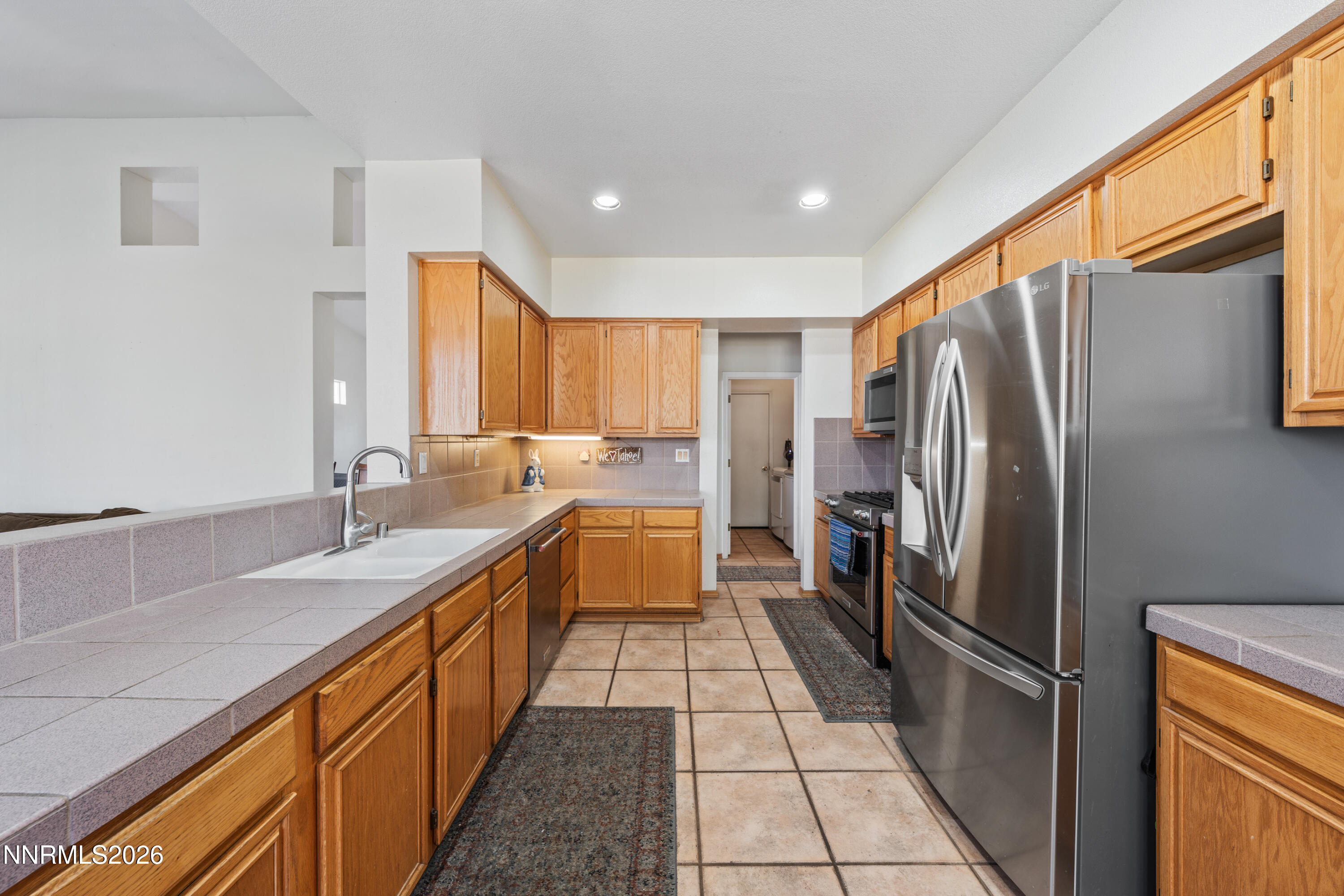 3225 Eaglewood Drive Reno, NV 89502 - Photo 7 of 45 a kitchen with stainless steel appliances granite countertop a refrigerator a sink and dishwasher
