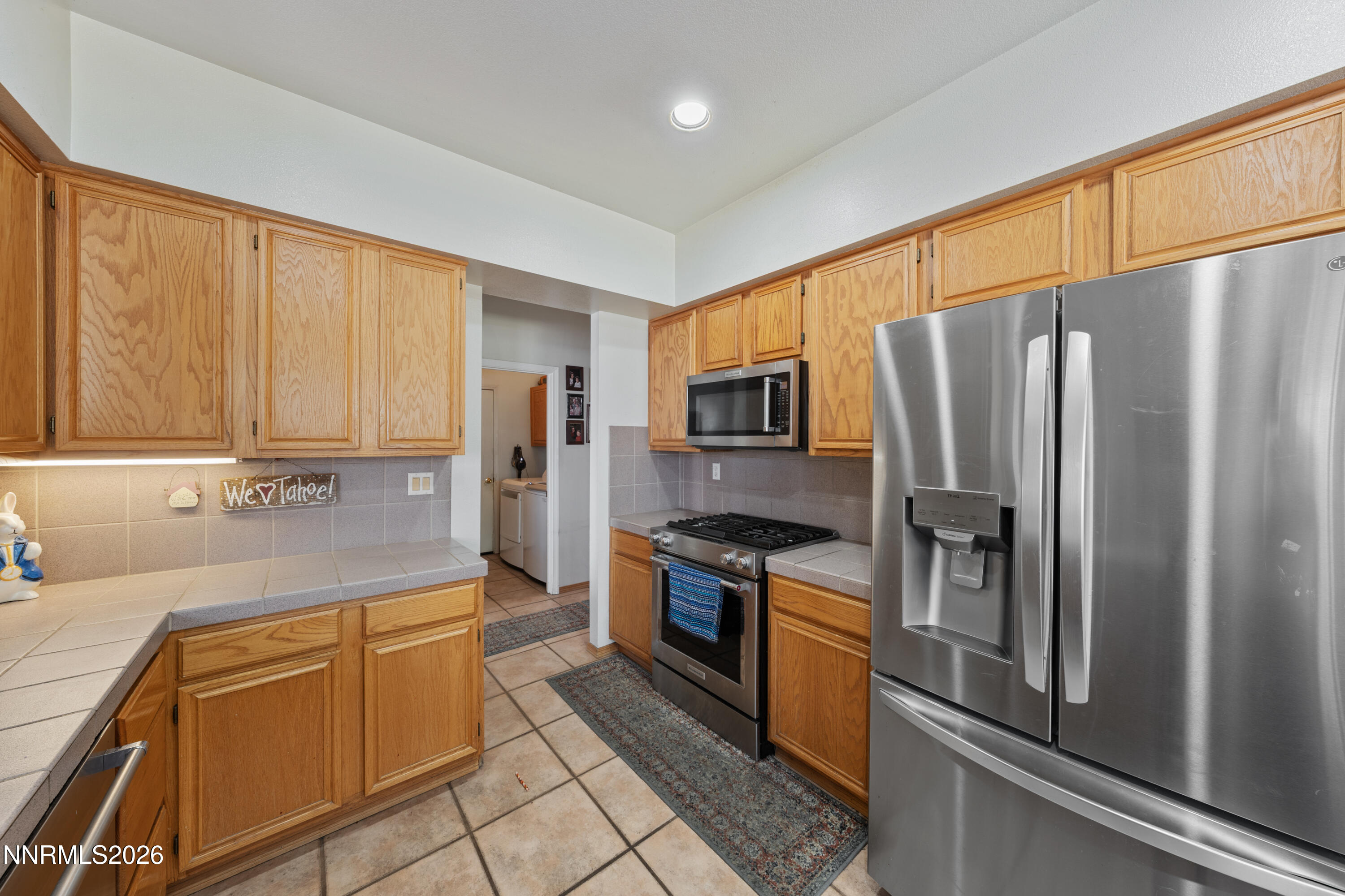 3225 Eaglewood Drive Reno, NV 89502 - Photo 8 of 45 a kitchen with stainless steel appliances granite countertop a refrigerator stove and sink