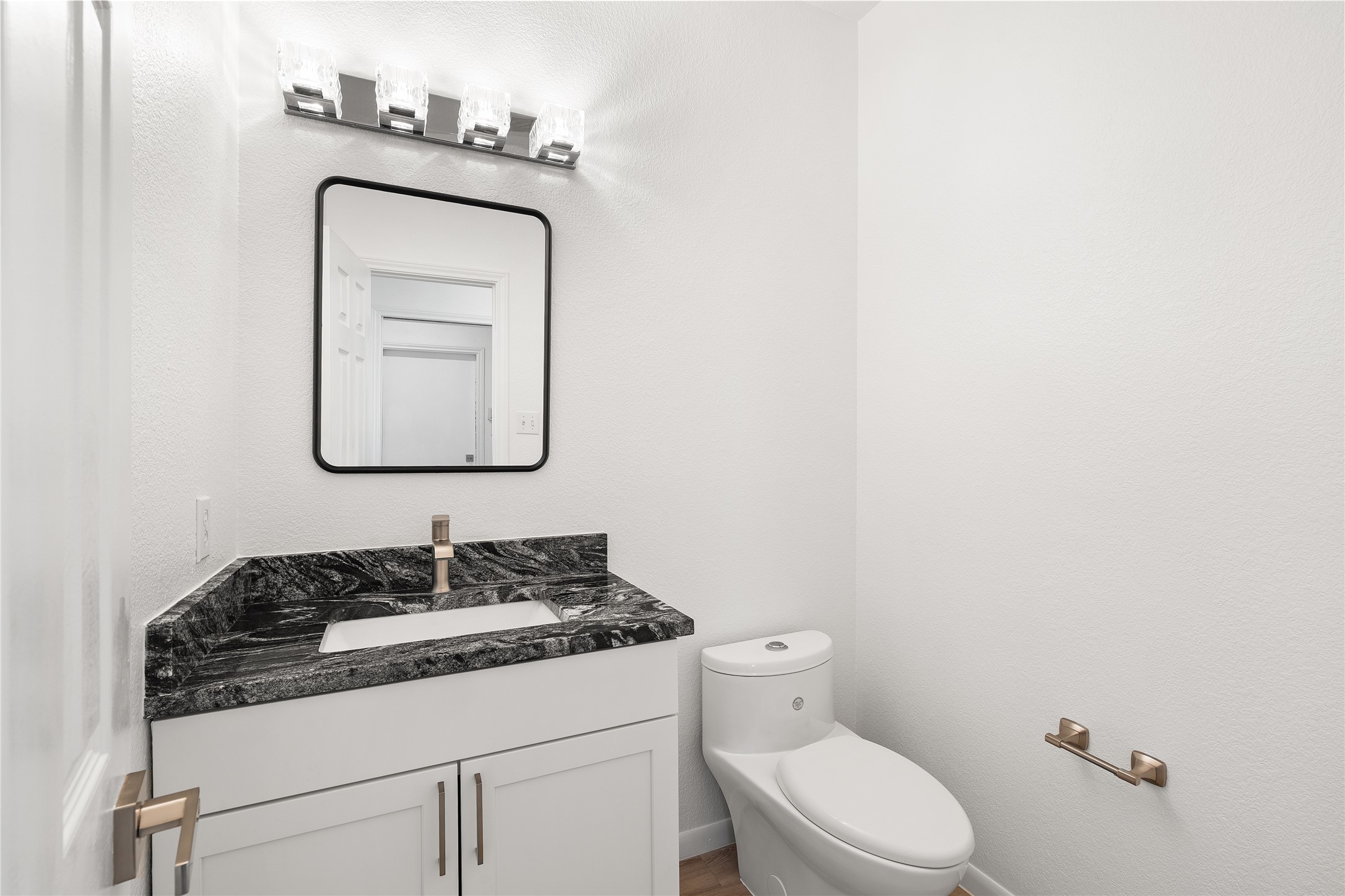 206 River Down Road Georgetown, TX 78628 - Photo 19 of 39 Bathroom featuring a white vanity cabinet with shaker-style doors, dark veined countertop, rectangular undermount sink, and a single-handle faucet
