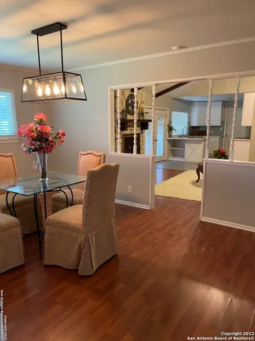 a living room with furniture a chandelier and a floor to ceiling window