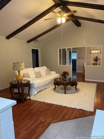 a bedroom with furniture and a wooden floor