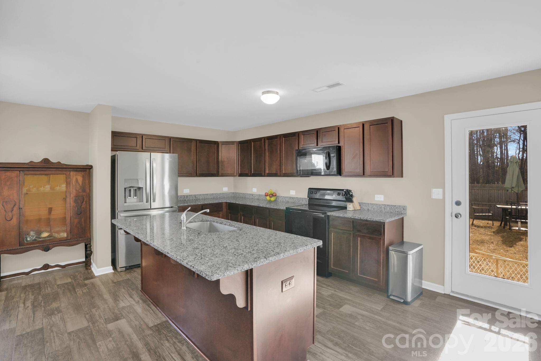 767 Gants Road York, SC 29745 - Photo 11 of 47 a kitchen with stainless steel appliances granite countertop a sink stove and refrigerator
