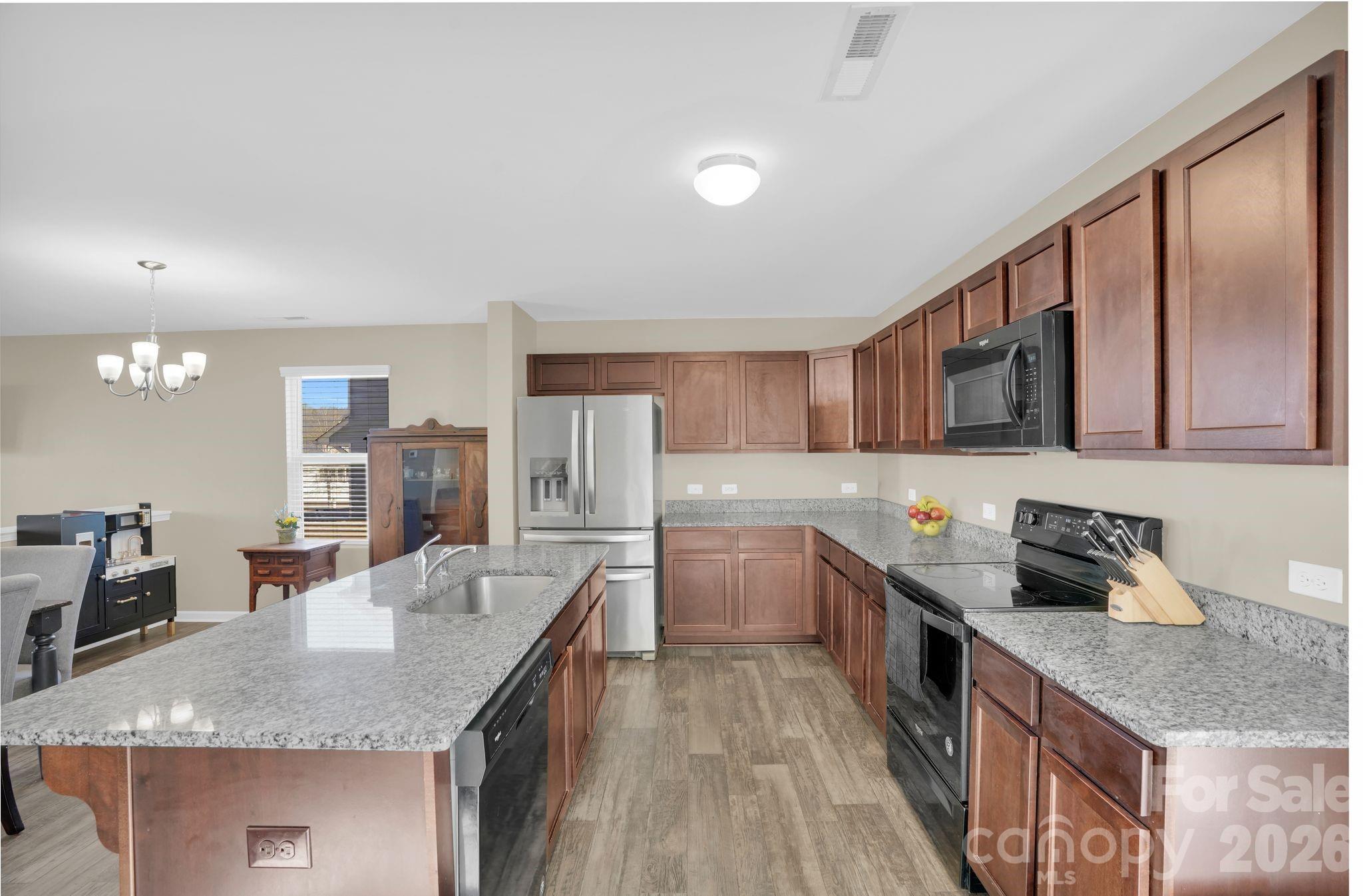 767 Gants Road York, SC 29745 - Photo 12 of 47 a kitchen with stainless steel appliances granite countertop a sink stove and refrigerator