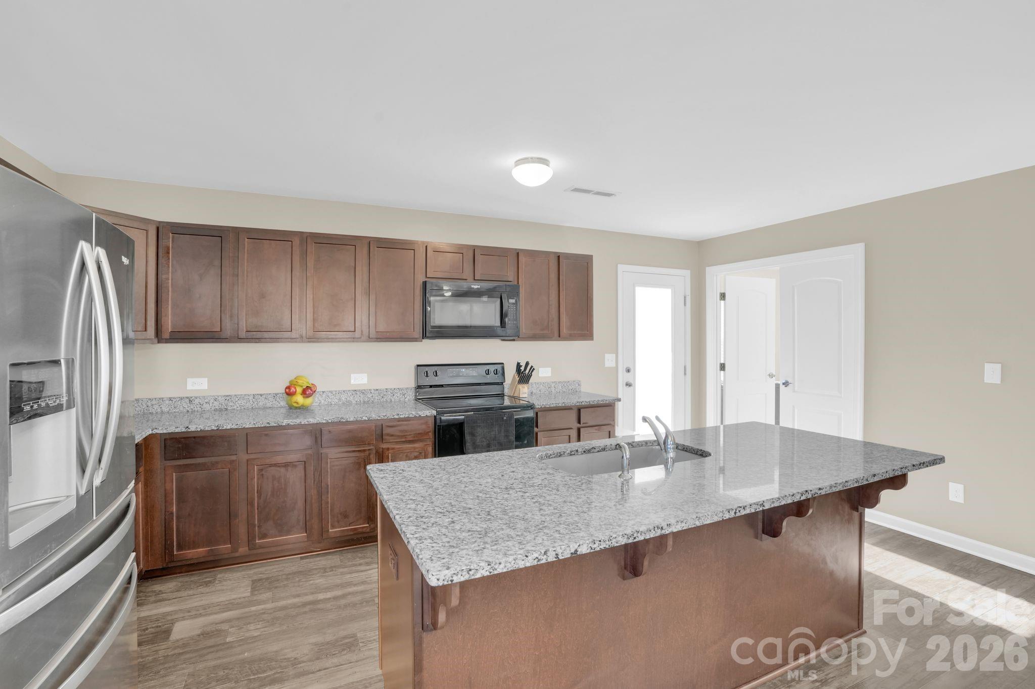 767 Gants Road York, SC 29745 - Photo 14 of 47 a kitchen with granite countertop a sink dishwasher stove and refrigerator with wooden floor