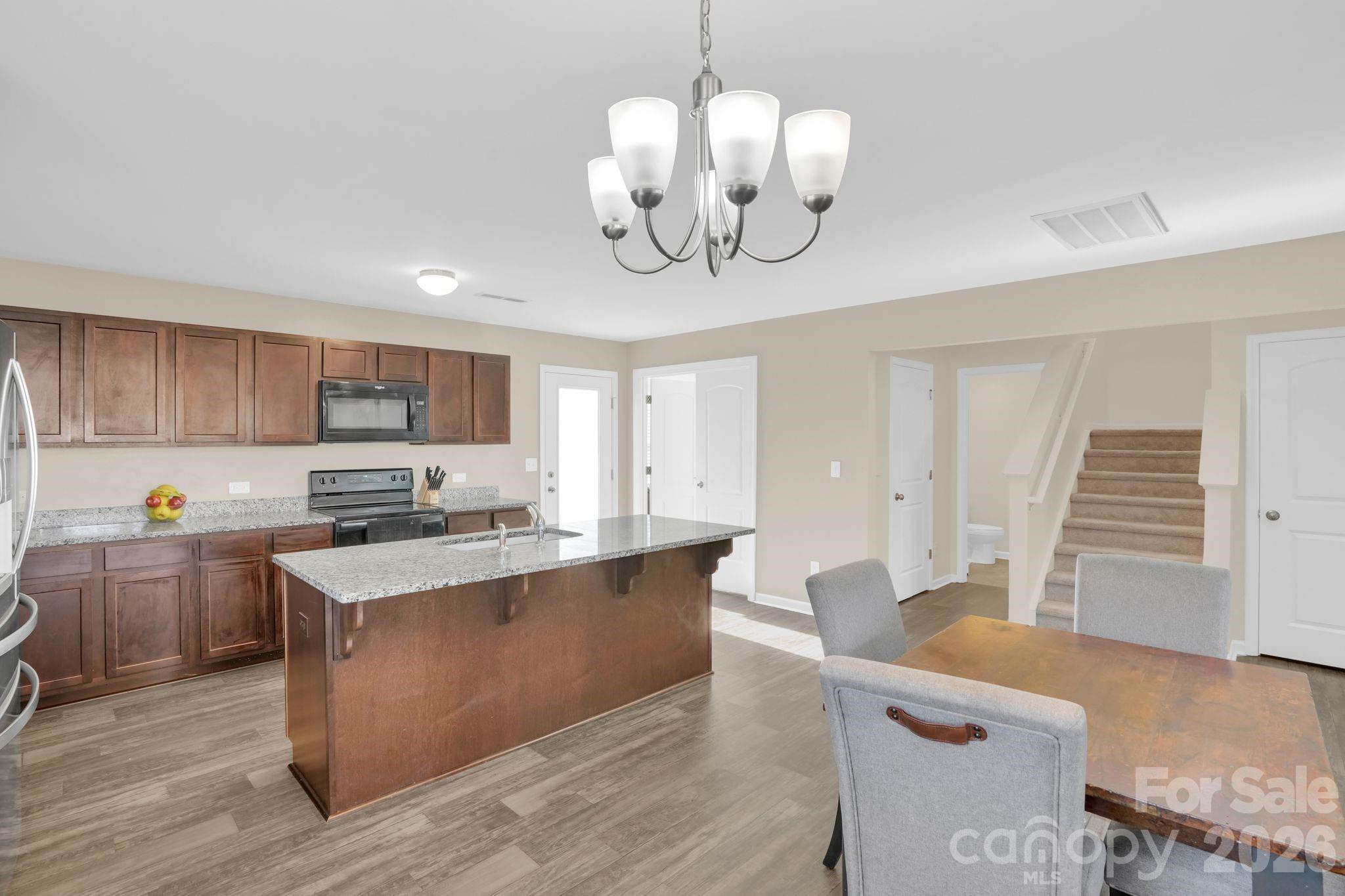767 Gants Road York, SC 29745 - Photo 15 of 47 a large kitchen with stainless steel appliances granite countertop a lot of cabinets and wooden floor
