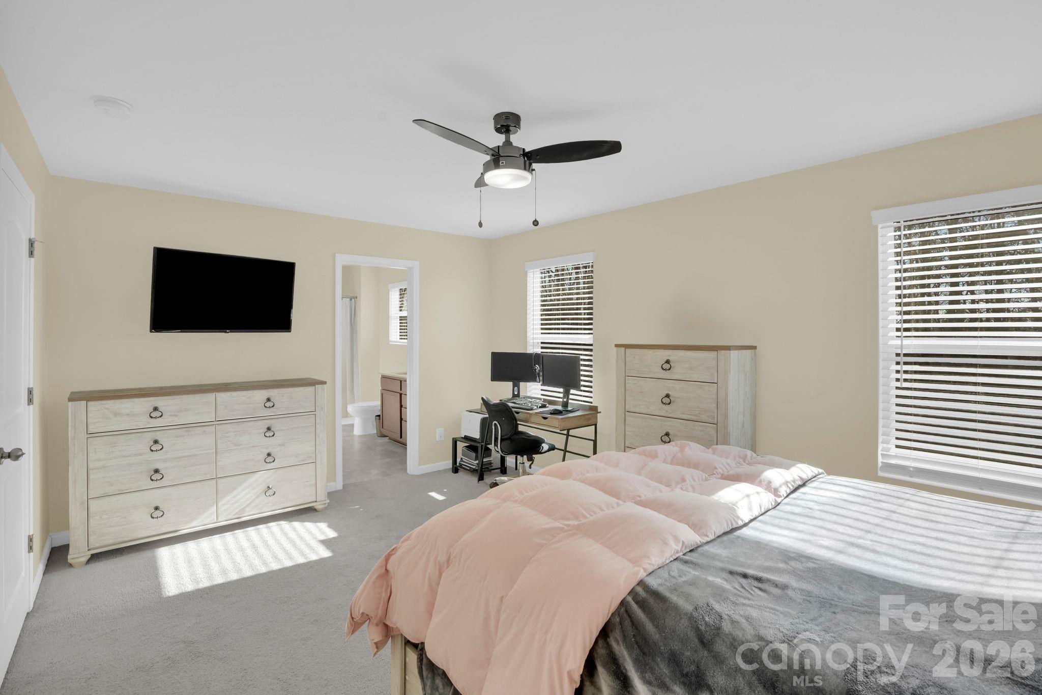 767 Gants Road York, SC 29745 - Photo 22 of 47 a bedroom with a bed a dresser and a flat screen tv