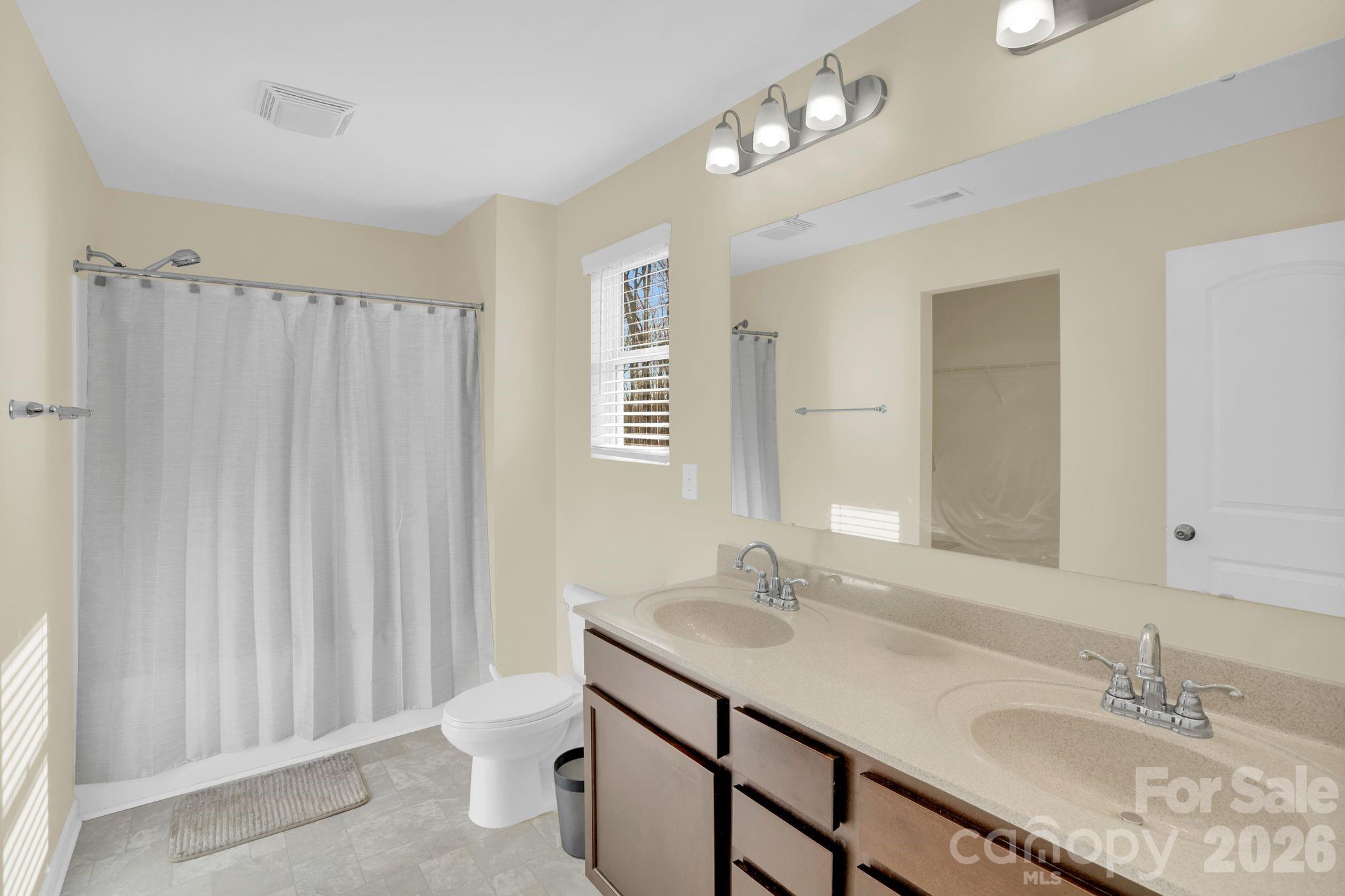 767 Gants Road York, SC 29745 - Photo 23 of 47 a bathroom with a granite countertop sink a toilet and a mirror