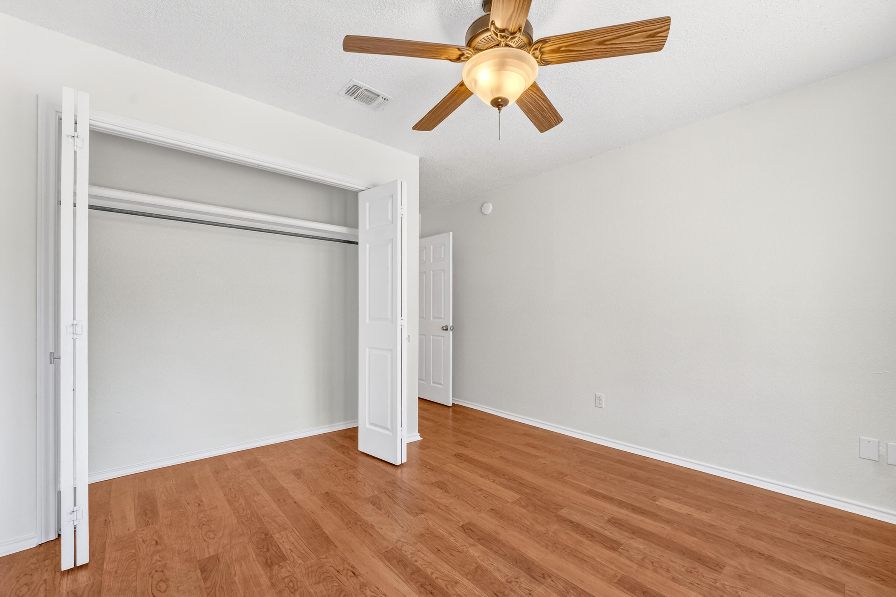 5221 84th Street Lubbock, TX 79424 - Photo 22 of 26 an empty room with wooden floor ceiling fan and window
