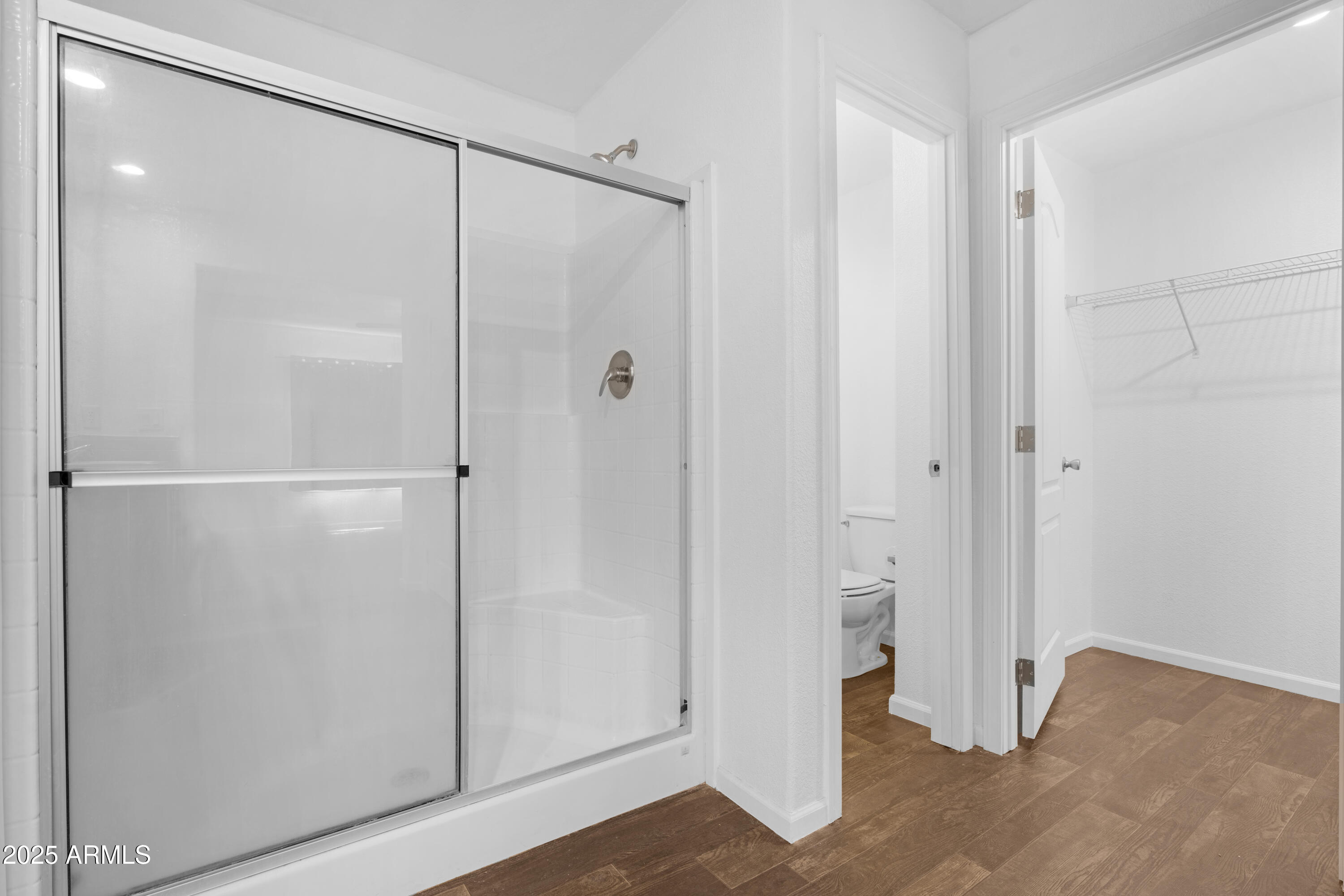 4318 North White Road Maricopa, AZ 85139 - Photo 9 of 21 a bathroom with a glass shower door