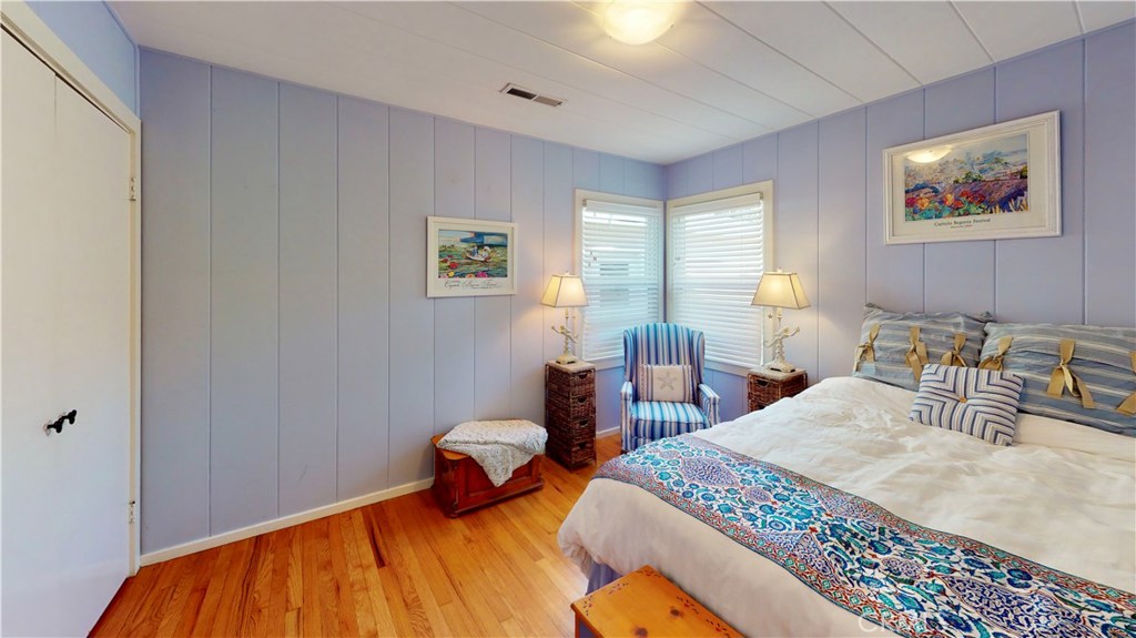 514 Middlefield Drive Aptos, CA 95003 - Photo 23 of 31 a bedroom with a bed and wooden floor