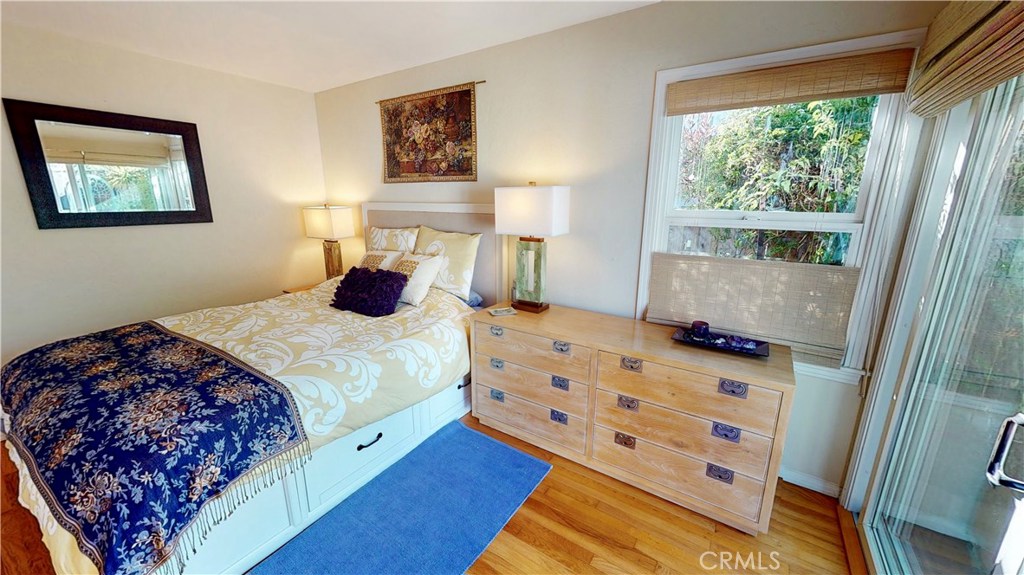 514 Middlefield Drive Aptos, CA 95003 - Photo 26 of 31 a bedroom with a bed a dresser next to a window