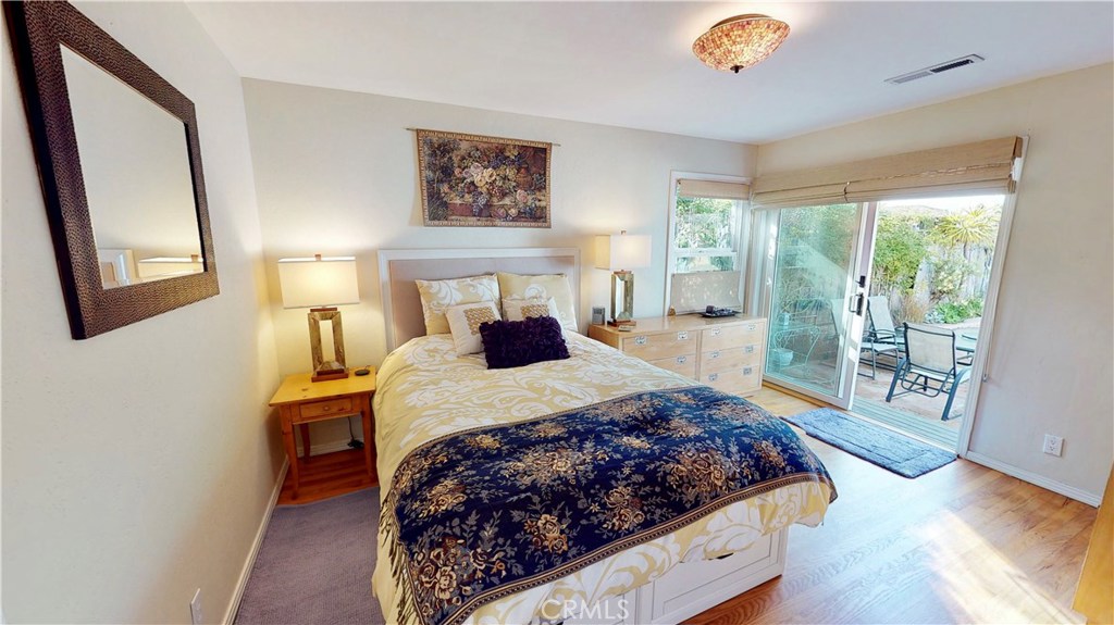 514 Middlefield Drive Aptos, CA 95003 - Photo 27 of 31 a bedroom with a large bed and a chandelier