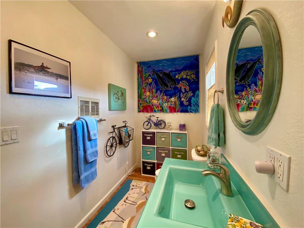 514 Middlefield Drive Aptos, CA 95003 - Photo 30 of 31 a bathroom with a sink mirror and wall paintings