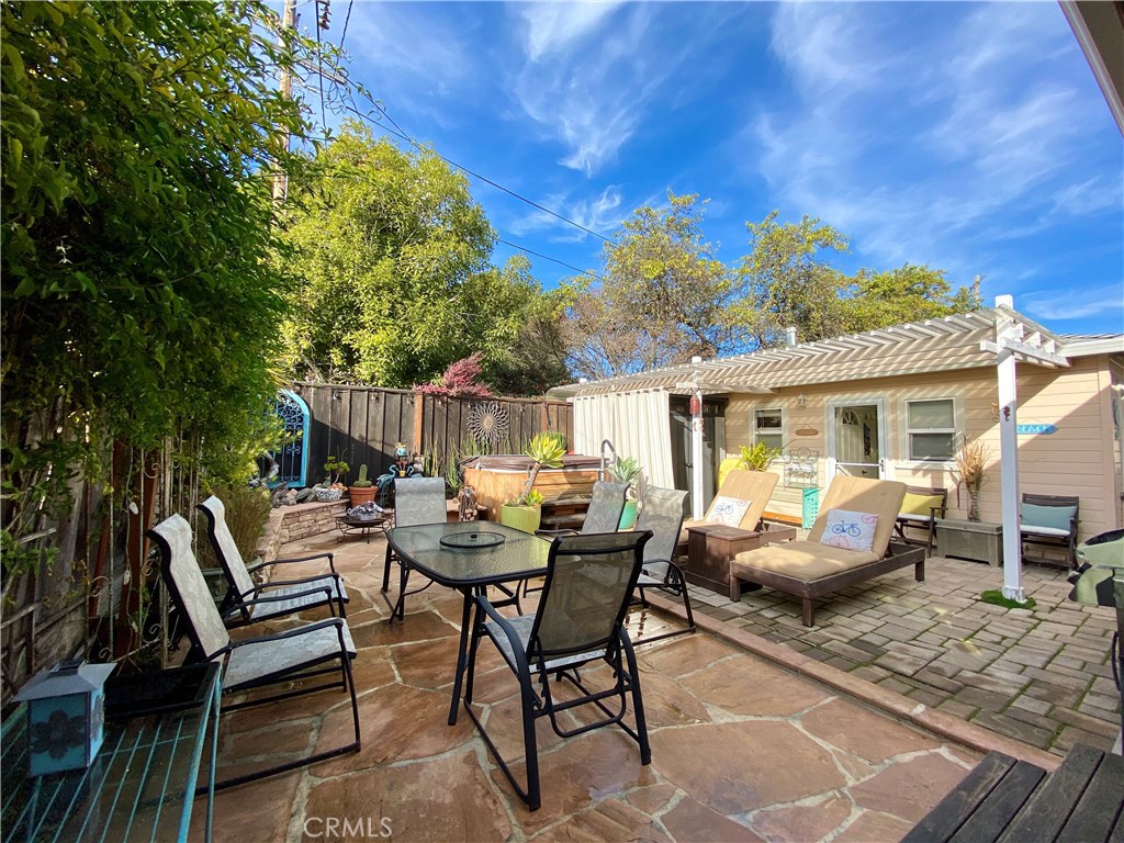 514 Middlefield Drive Aptos, CA 95003 - Photo 6 of 31 a view of a patio with a dining table and chairs with wooden floor