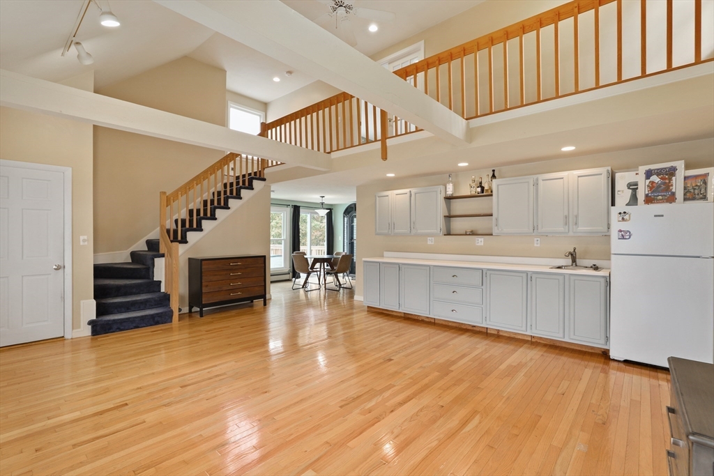 a view of kitchen with furniture and wooden floor