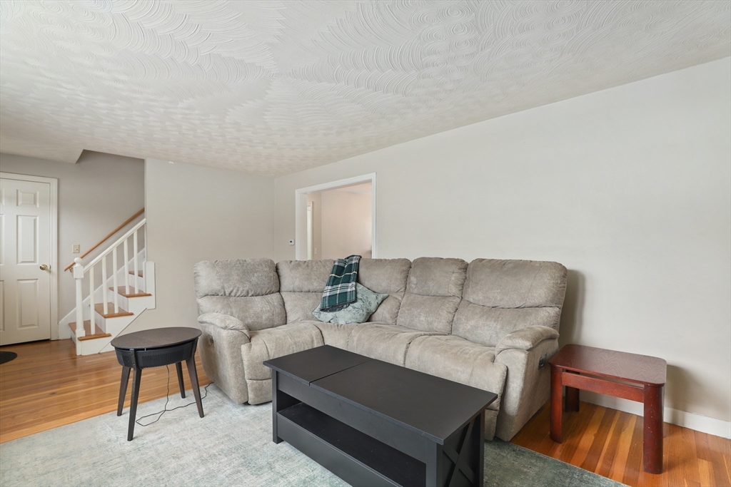27 Pollard Drive Millis, MA 02054 - Photo 14 of 41 a living room with furniture and a wooden floor